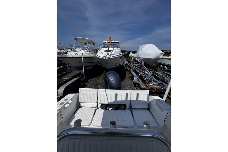 Slide: The Image of Boats docked on land, featuring a 2017 Release 210RX model under a clear blue sky. - 20