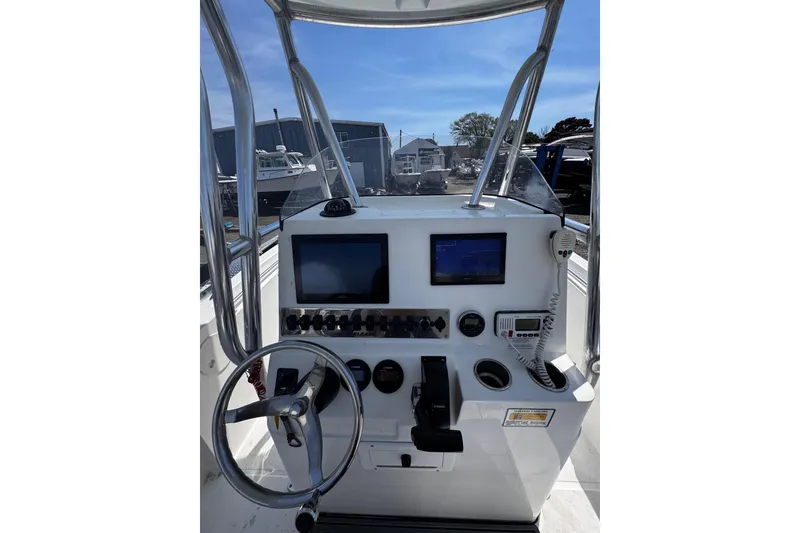 Slide: The Image of 2017 Release 210RX boat console with steering wheel, navigation screens, and controls. - 22
