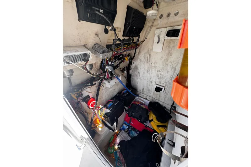 Slide: The Image of Interior of a 2017 Release 210RX boat showing wiring and equipment storage. - 23