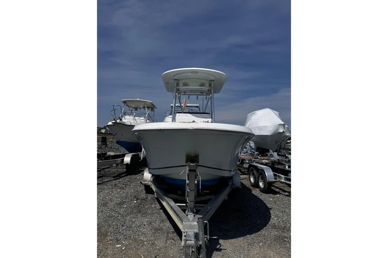 Slide: The Image of 2017 Release 210RX boat on trailer, parked outdoors under clear sky. - 26
