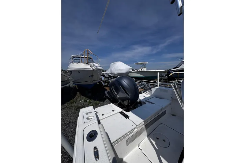 Slide: The Image of Boats docked under clear sky, featuring a 2017 Release 210RX model. - 9
