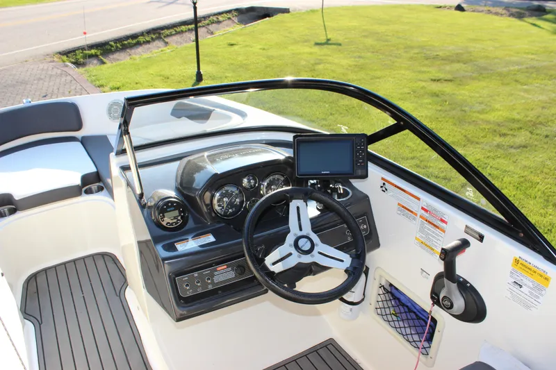 Slide: The Image of 2020 Bayliner VR6 Bowrider I/O dashboard with steering wheel and navigation display. - 12