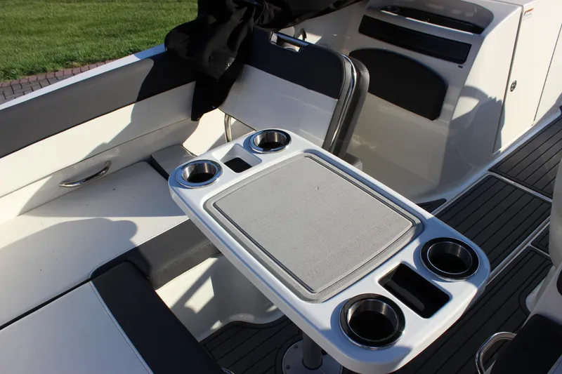 Slide: The Image of 2020 Bayliner VR6 Bowrider I/O interior with table and cup holders. - 13