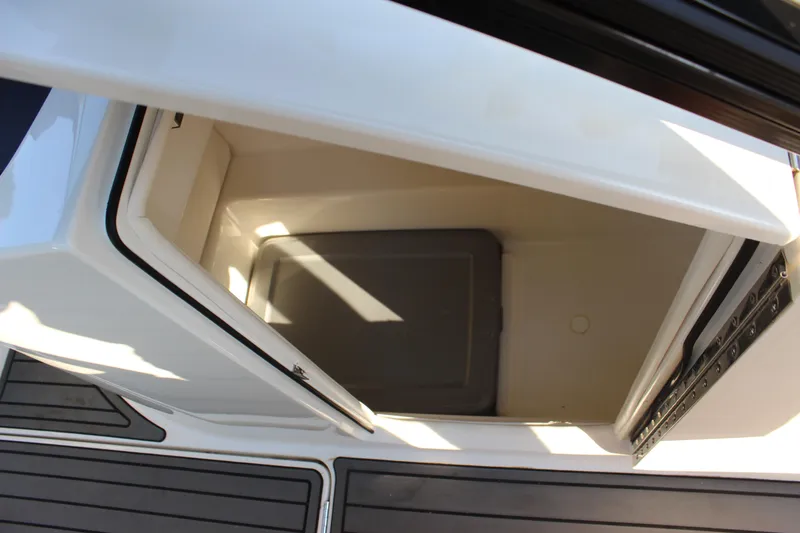 Slide: The Image of 2020 Bayliner VR6 Bowrider I/O storage compartment with open hatch and sleek design. - 15