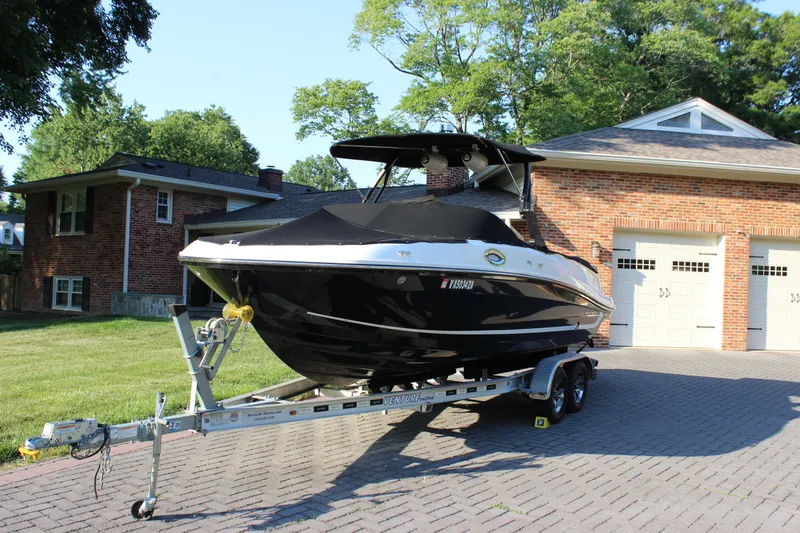 Slide: The Image of 2020 Bayliner VR6 Bowrider I/O on trailer in residential driveway. - 2