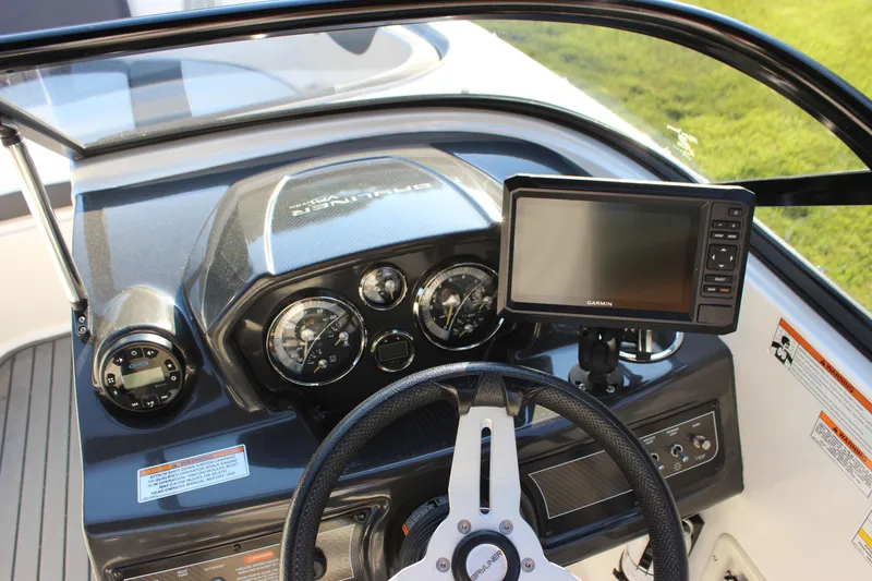 Slide: The Image of 2020 Bayliner VR6 Bowrider I/O dashboard with steering wheel and Garmin navigation system. - 22