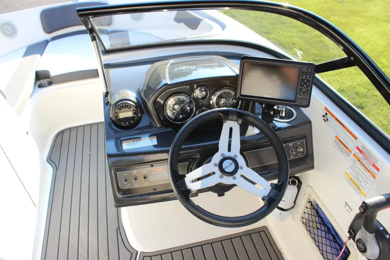 Slide: The Image of 2020 Bayliner VR6 Bowrider I/O dashboard with steering wheel and navigation display. - 24
