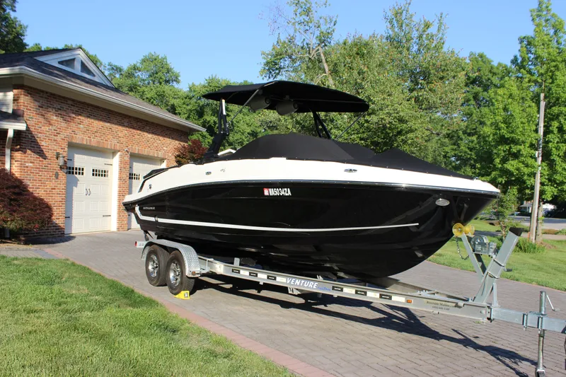 Slide: The Image of 2020 Bayliner VR6 Bowrider I/O on trailer, parked in driveway near brick garage. - 3