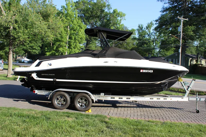 Slide: The Image of 2020 Bayliner VR6 Bowrider I/O on trailer, parked outdoors with trees in background. - 4