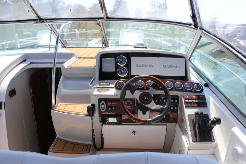 Slide: The Image of 2005 Formula 31 Performance Cruiser helm with Garmin navigation displays and wood-accented controls. - 14