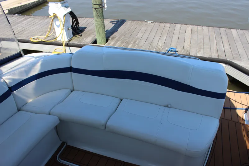 Slide: The Image of 2005 Formula 31 Performance Cruiser interior with white seating and blue accents at dock. - 18
