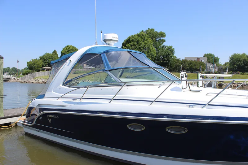 Slide: The Image of 2005 Formula 31 Performance Cruiser docked by a scenic waterfront. - 31