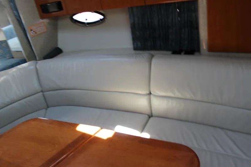 Slide: The Image of Interior of 2005 Formula 31 Performance Cruiser with white leather seating and wooden table. - 48