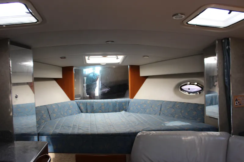 Slide: The Image of Interior of 2005 Formula 31 Performance Cruiser with blue seating and porthole window. - 49