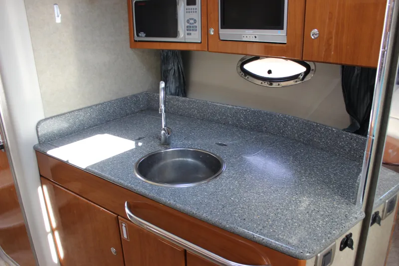 Slide: The Image of 2005 Formula 31 Performance Cruiser galley with sink, microwave, and porthole window. - 50