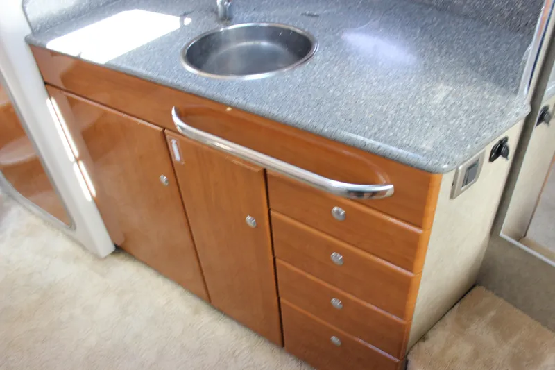 Slide: The Image of 2005 Formula 31 Performance Cruiser interior with wooden cabinetry and stainless steel sink. - 51