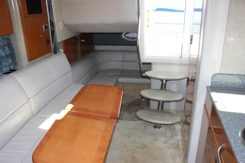 Slide: The Image of Interior of 2005 Formula 31 Performance Cruiser with modern seating and wooden table. - 57