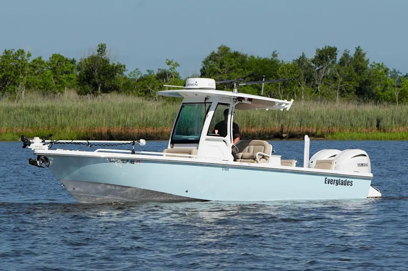 The Image of 2019 Everglades 273 Center Console boat cruising on a calm lake. - 1