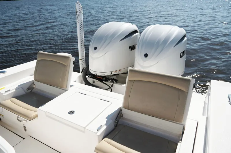 Slide: The Image of 2019 Everglades 273 Center Console boat with twin Yamaha engines on water. - 14