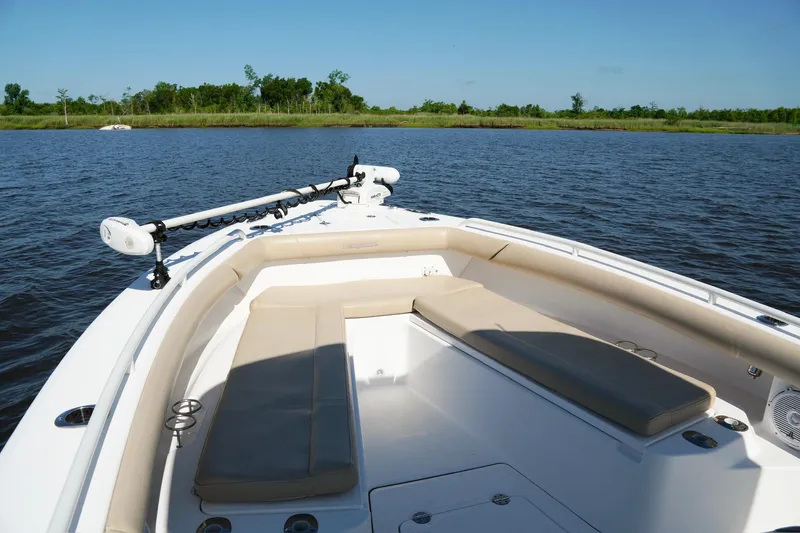 Slide: The Image of 2019 Everglades 273 Center Console boat on calm water, featuring spacious seating. - 16