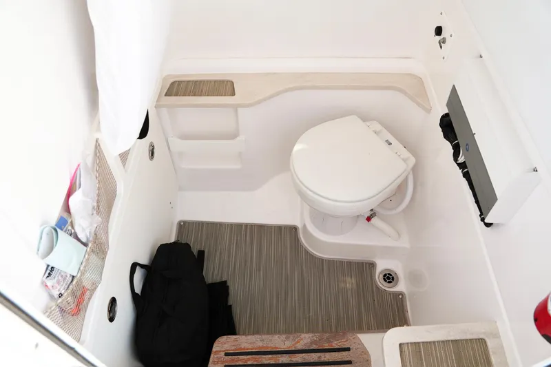 Slide: The Image of Interior of 2019 Everglades 273 Center Console boat bathroom with toilet and storage. - 20