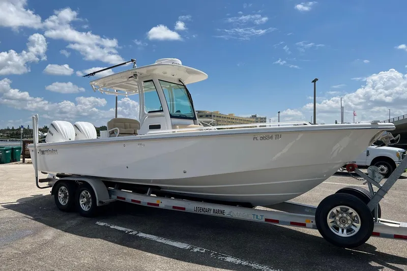 Slide: The Image of 2019 Everglades 273 Center Console boat on trailer under clear blue sky. - 22