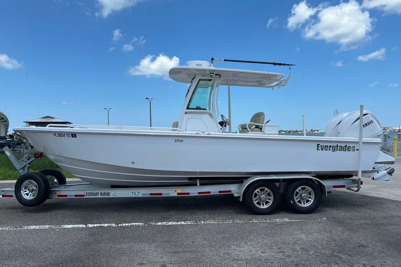Slide: The Image of 2019 Everglades 273 Center Console boat on trailer under blue sky. - 24