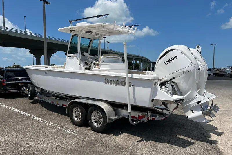 Slide: The Image of 2019 Everglades 273 Center Console boat on trailer, parked near a bridge. - 25