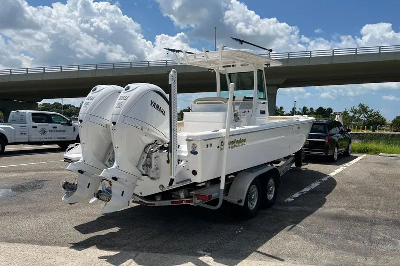 Slide: The Image of 2019 Everglades 273 Center Console boat with twin Yamaha engines on a trailer. - 27