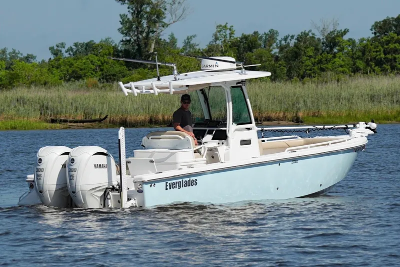 Slide: The Image of 2019 Everglades 273 Center Console boat cruising on a scenic waterway. - 5