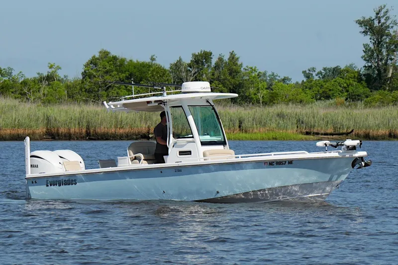 Slide: The Image of 2019 Everglades 273 Center Console boat cruising on a calm river. - 6