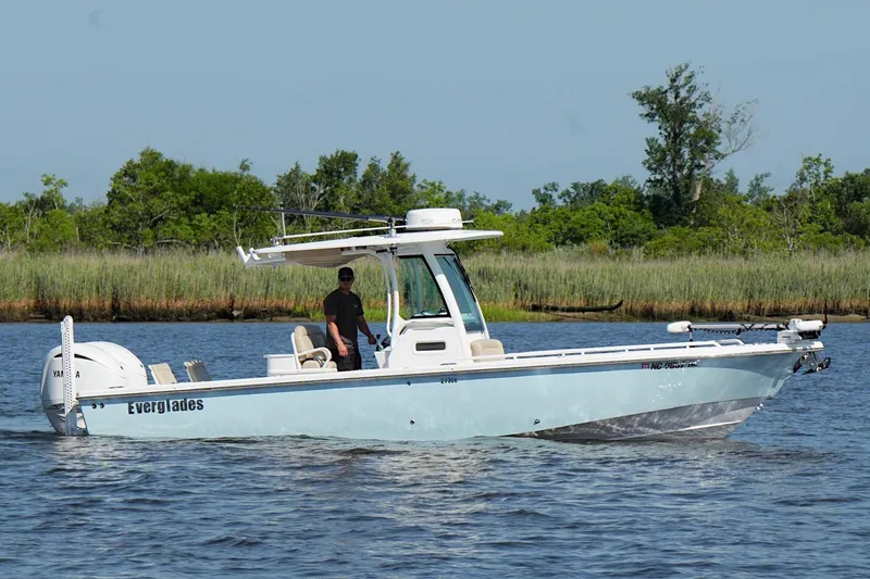Slide: The Image of 2019 Everglades 273 Center Console boat cruising on a calm river. - 8