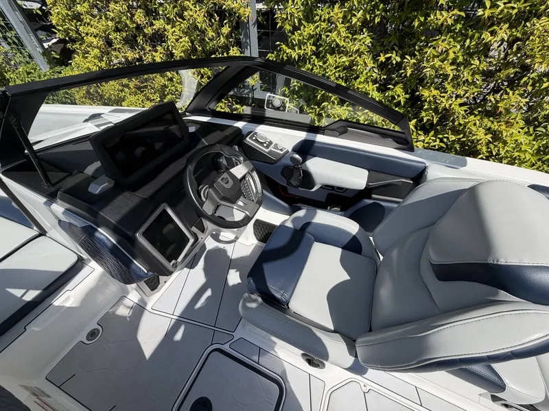 Slide: The Image of Interior of a 2022 Malibu M220 boat with modern helm console. - 14