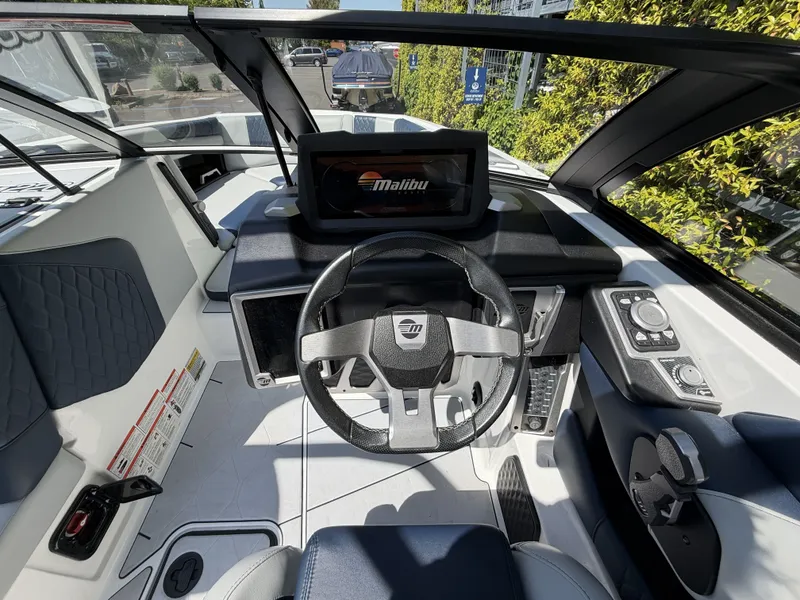 Slide: The Image of Interior view of 2022 Malibu M220 helm with steering wheel and display. - 15