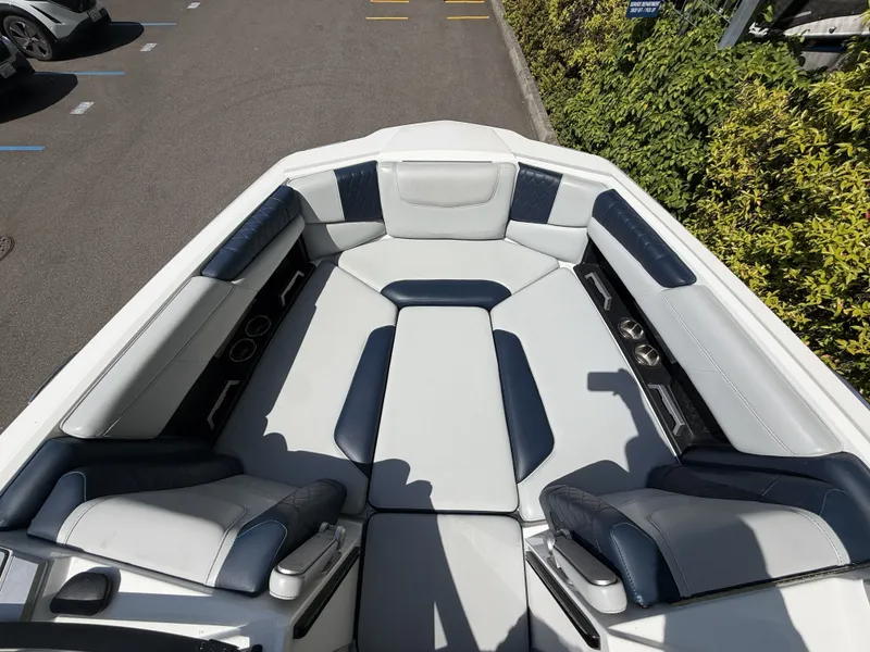 Slide: The Image of Interior of a 2022 Malibu M220 boat with blue and gray seating. - 17
