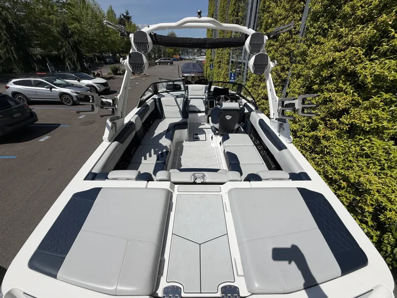 Slide: The Image of Interior view of a 2022 Malibu M220 boat outdoors. - 2
