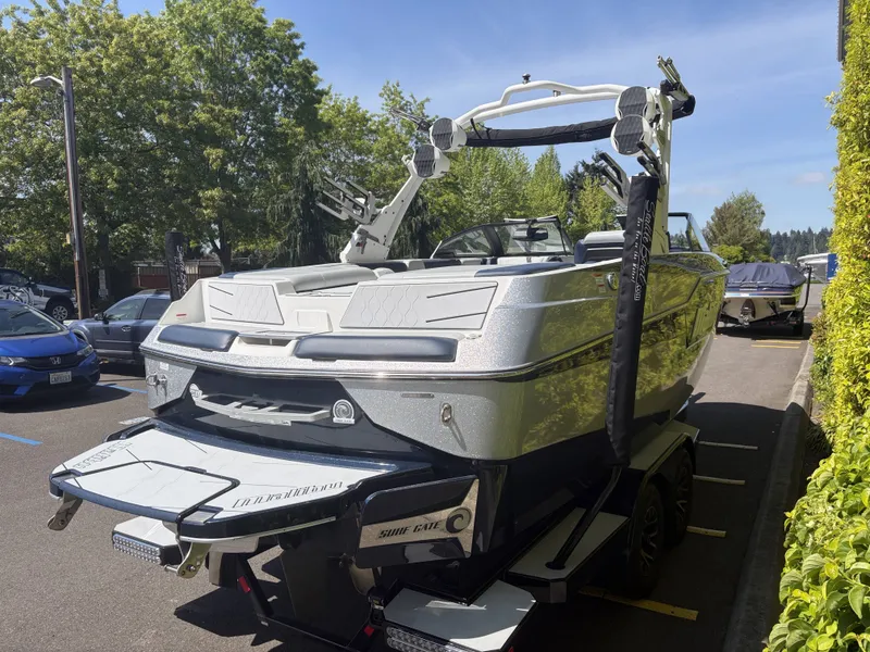 Slide: The Image of 2022 Malibu M220 boat parked in sunny weather. - 5