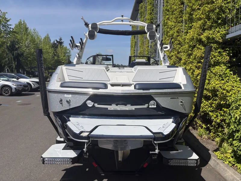Slide: The Image of Rear view of a 2022 Malibu M220 boat outdoors. - 6