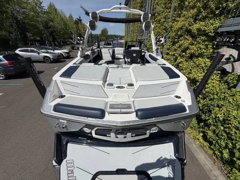 Slide: The Image of 2022 Malibu M220 boat in parking lot, modern features. - 8