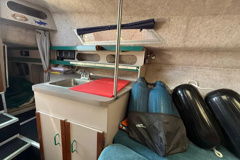 Slide: The Image of Interior of 1988 Cruisers Yachts 2470 Holiday with kitchenette and storage area. - 10