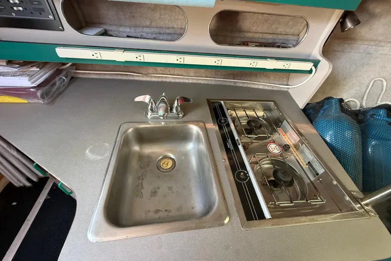 Slide: The Image of 1988 Cruisers Yachts 2470 Holiday kitchen with sink and stove. - 11
