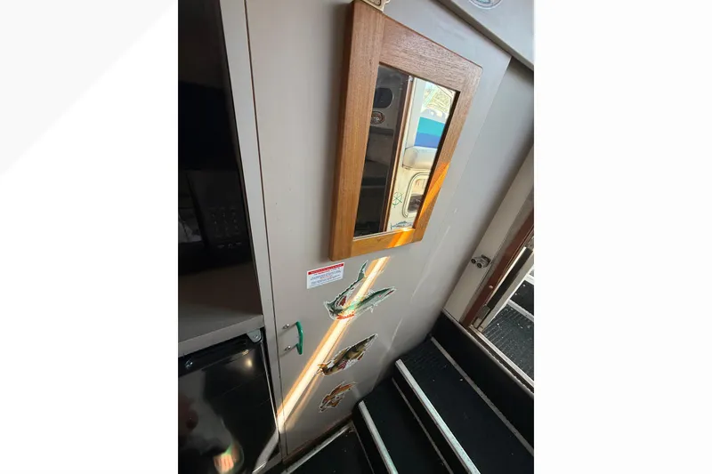 Slide: The Image of Interior view of 1988 Cruisers Yachts 2470 Holiday with mirror and decorative fish. - 18