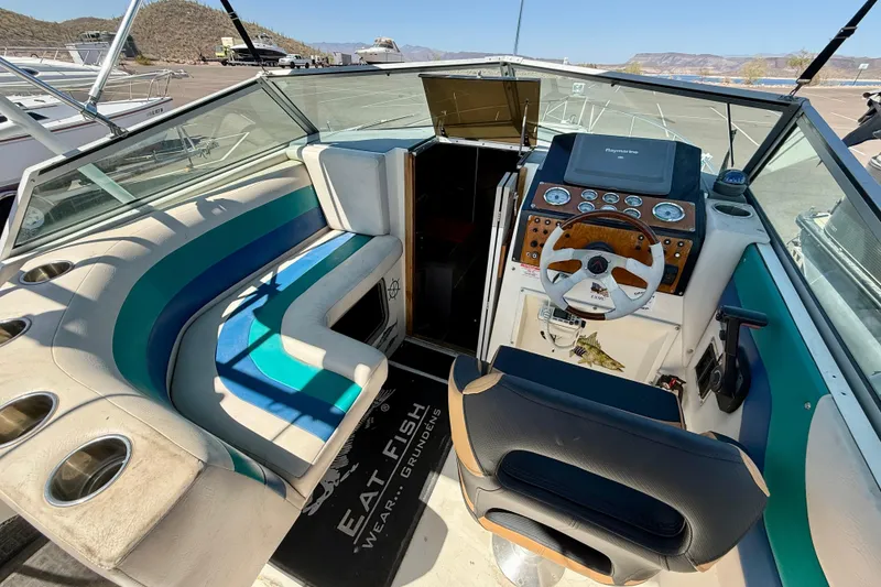 Slide: The Image of 1988 Cruisers Yachts 2470 Holiday boat interior with steering wheel and seating. - 19