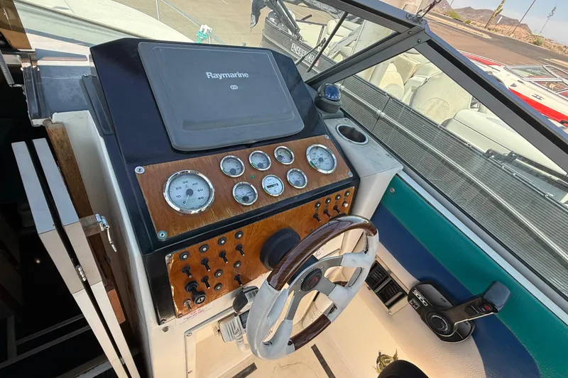 Slide: The Image of 1988 Cruisers Yachts 2470 Holiday dashboard with Raymarine navigation system and gauges. - 22