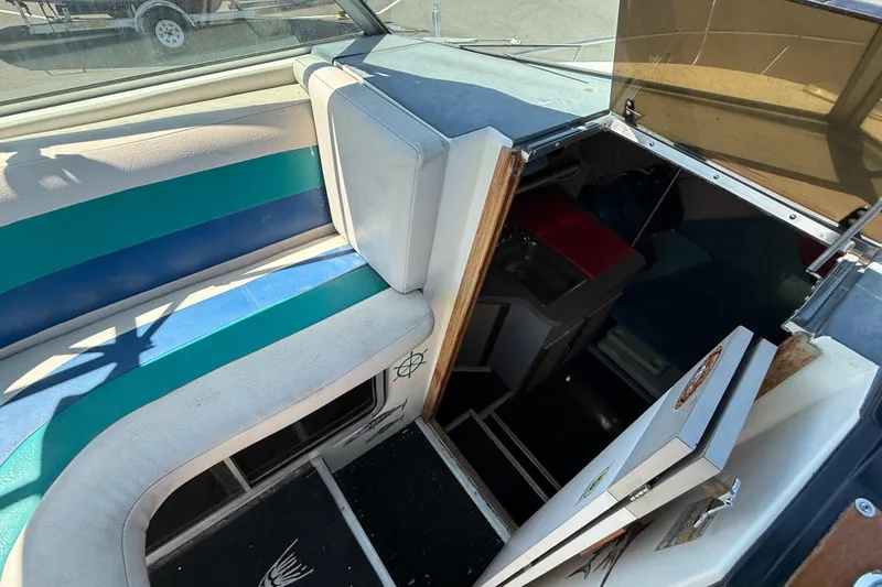 Slide: The Image of Interior view of a 1988 Cruisers Yachts 2470 Holiday, showcasing seating and cabin entrance. - 23