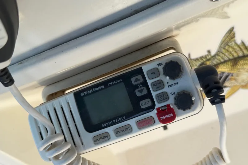 Slide: The Image of VHF marine radio on 1988 Cruisers Yachts 2470 Holiday, featuring distress button and controls. - 26