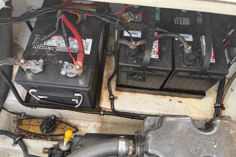 Slide: The Image of Batteries in 1988 Cruisers Yachts 2470 Holiday engine compartment, showing wiring and connections. - 31