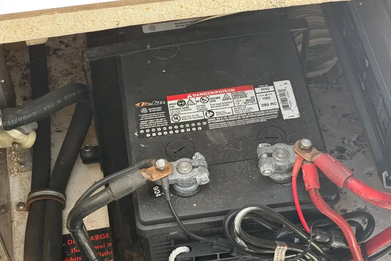 Slide: The Image of Battery compartment of 1988 Cruisers Yachts 2470 Holiday with connected cables. - 32