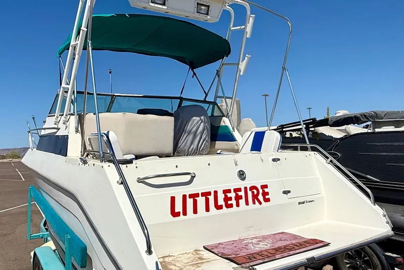 Slide: The Image of 1988 Cruisers Yachts 2470 Holiday boat named "Littlefire" in a parking lot. - 4