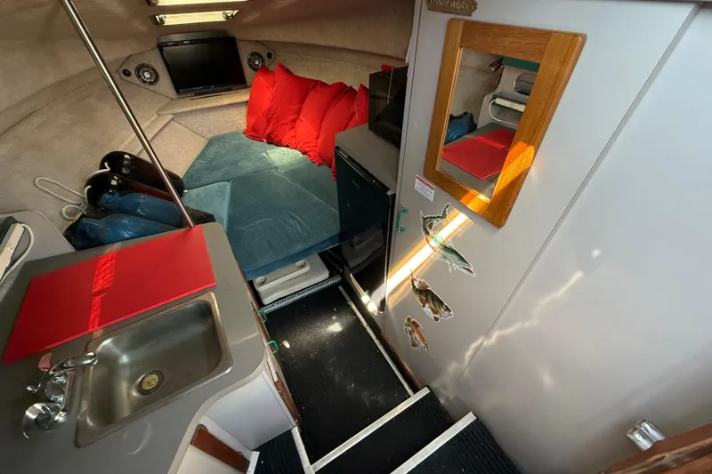 Slide: The Image of Interior of 1988 Cruisers Yachts 2470 Holiday with cozy seating and kitchenette. - 5